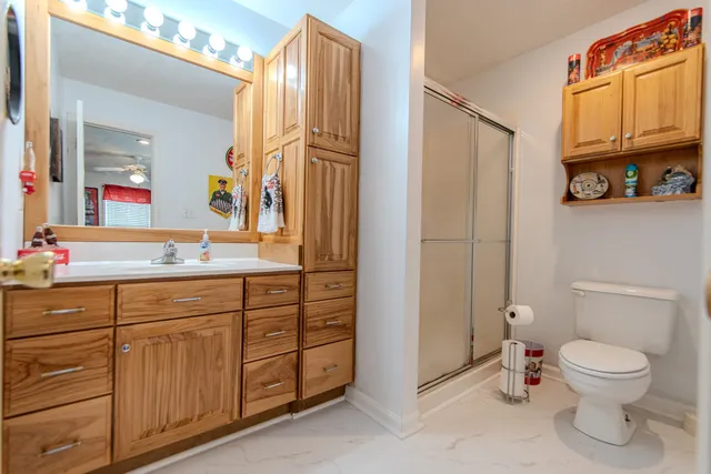 a bathroom with a toilet a sink and a mirror