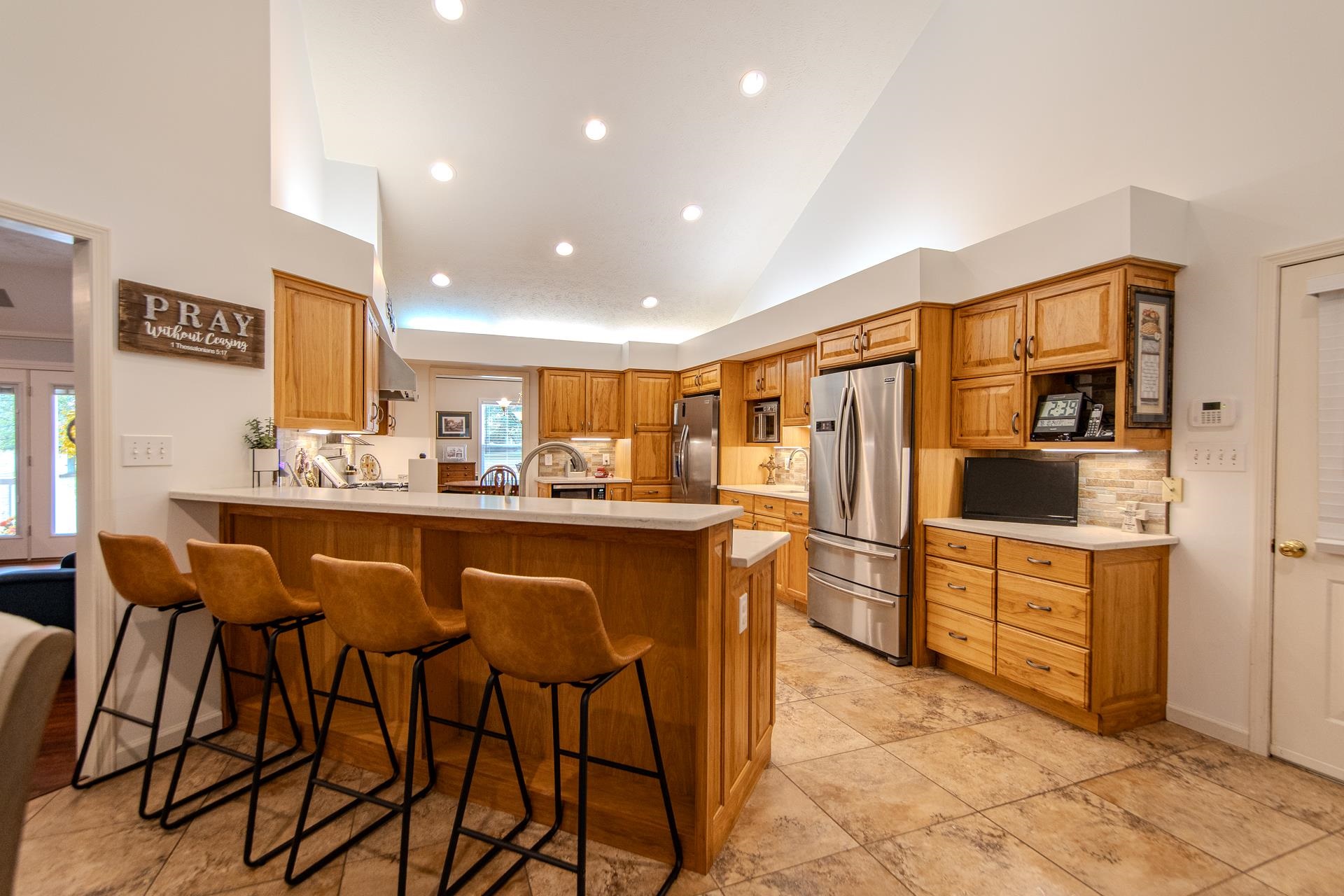 485 Robin Hood Loop Savannah, TN 38372 - Photo 29 of 40 a kitchen with refrigerator cabinets dining table and chairs