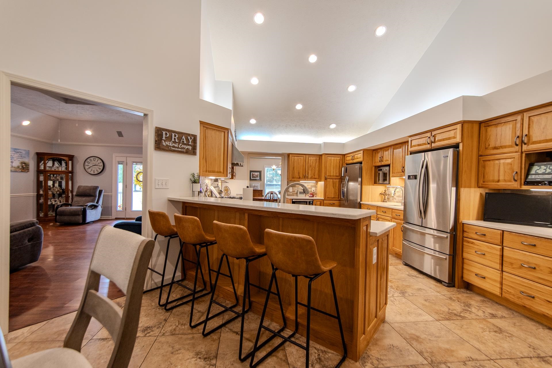 485 Robin Hood Loop Savannah, TN 38372 - Photo 8 of 40 a kitchen with stainless steel appliances kitchen island granite countertop a refrigerator and cabinets