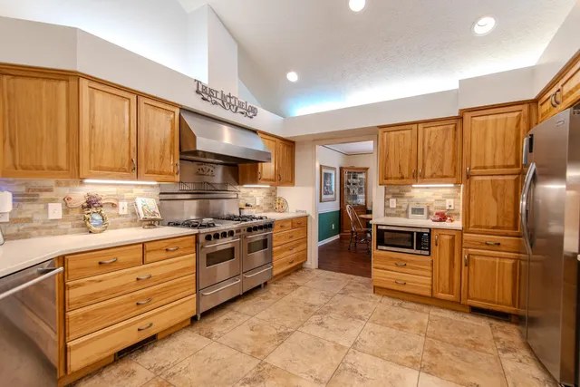 a kitchen with granite countertop stainless steel appliances and cabinets