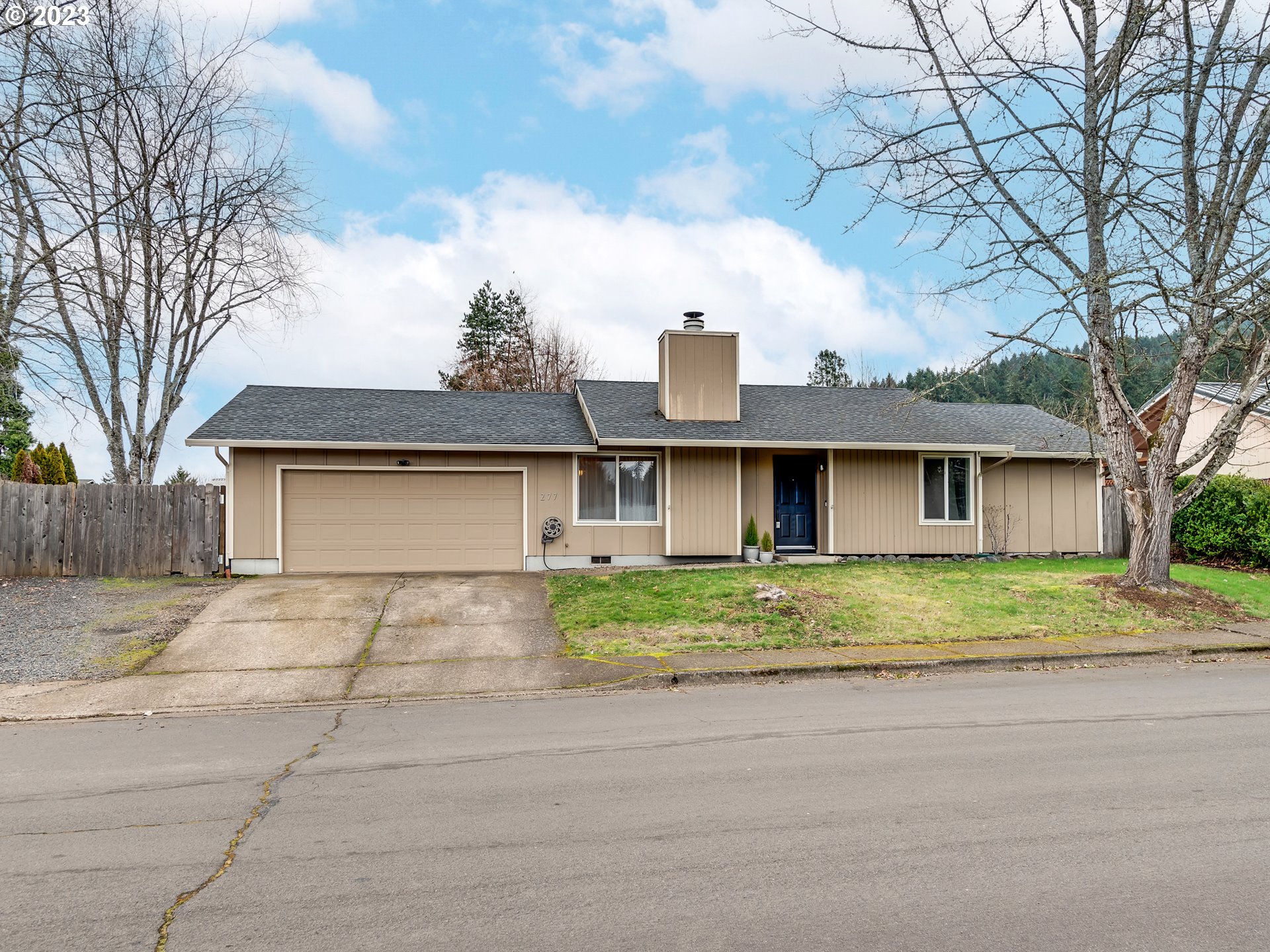 277 South 70th Place Springfield, OR 97478 - Photo 26 of 26 a view of a house with large trees next to a road