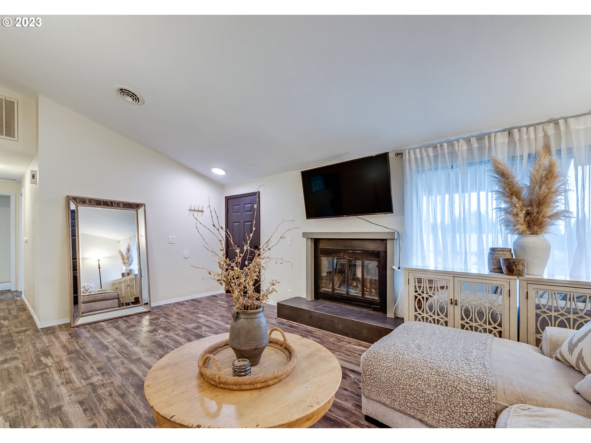 277 South 70th Place Springfield, OR 97478 - Photo 3 of 26 a living room with furniture a fireplace and a flat screen tv