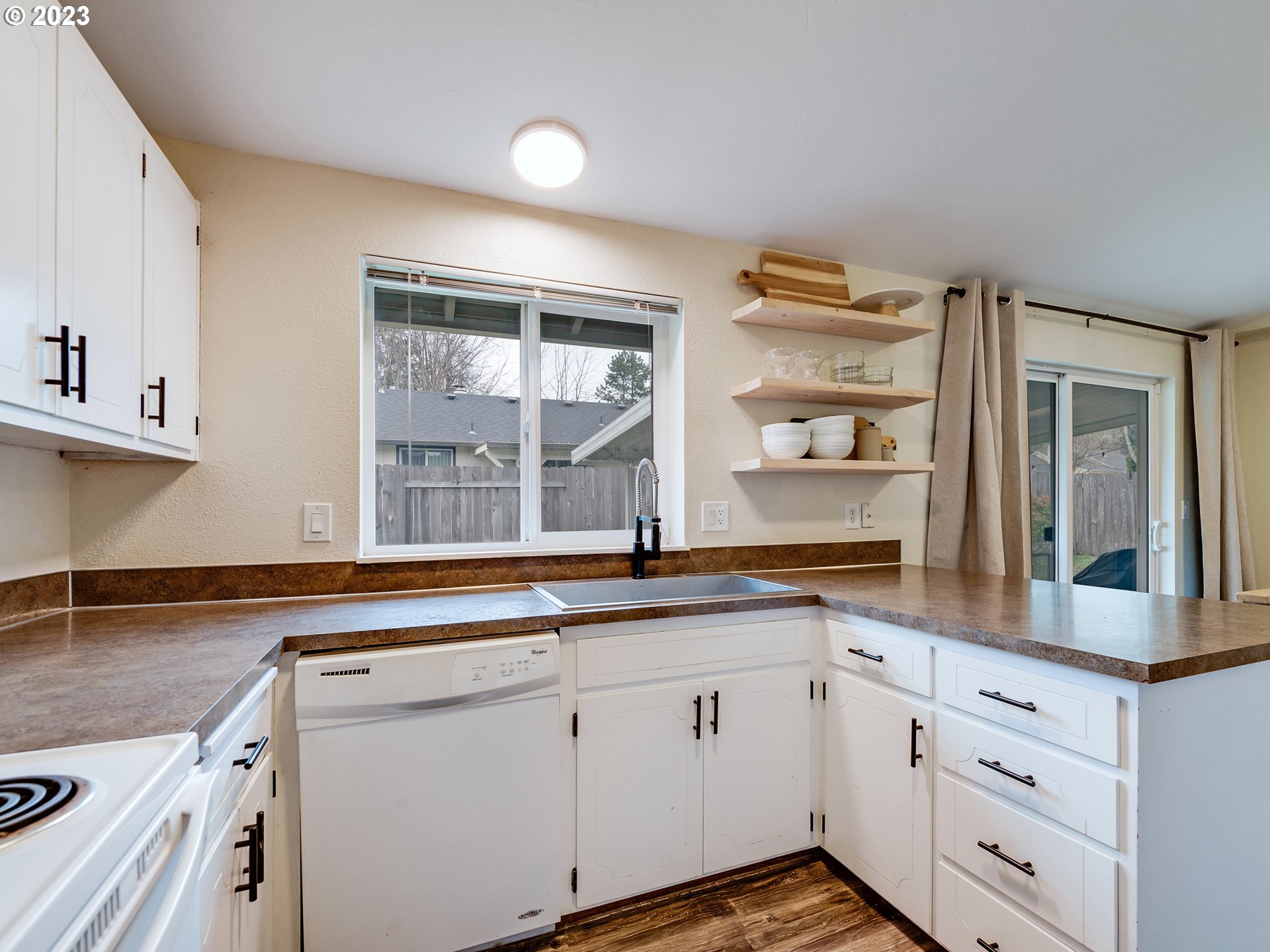 277 South 70th Place Springfield, OR 97478 - Photo 8 of 26 a kitchen with granite countertop white cabinets and white appliances