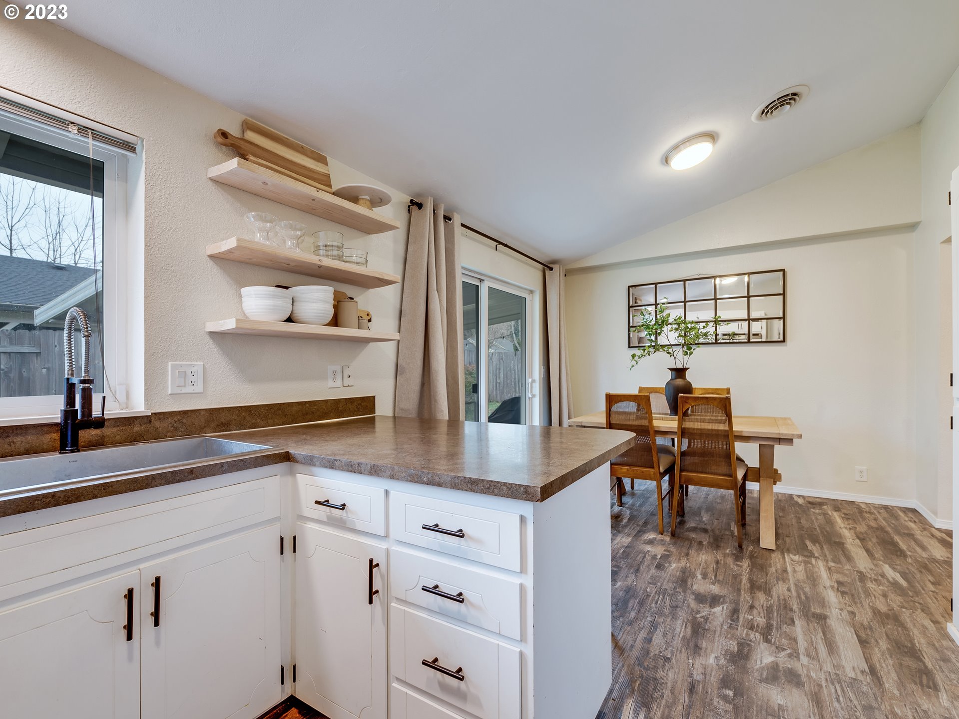 277 South 70th Place Springfield, OR 97478 - Photo 9 of 26 a kitchen with granite countertop white cabinets and white appliances