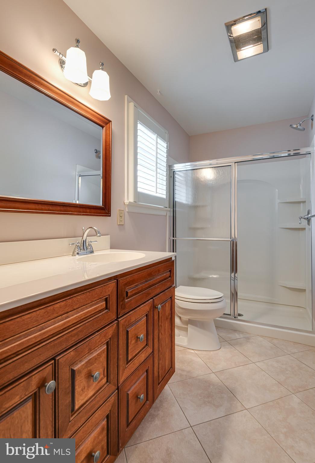 108 Sheeder Road Phoenixville, PA 19460 - Photo 26 of 42 a spacious bathroom with a shower sink and mirror