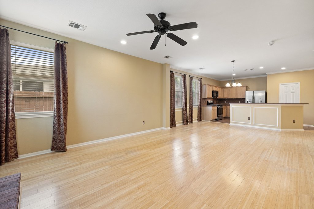 347 Spring Drive Kyle, TX 78640 - Photo 23 of 40 An open concept living area seamlessly flows into a well-appointed kitchen, ideal for entertaining.
