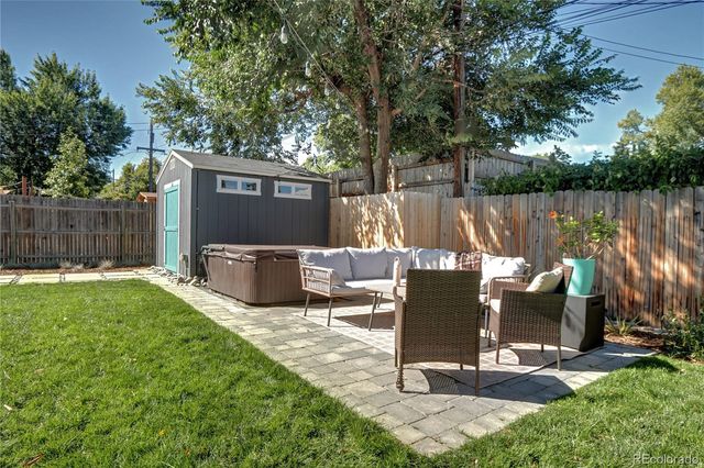 a view of a patio with a table chairs and a fire pit