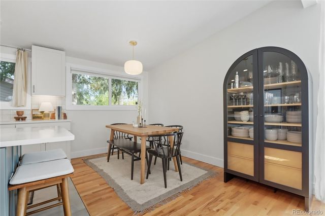a view of a dining room with furniture and a window