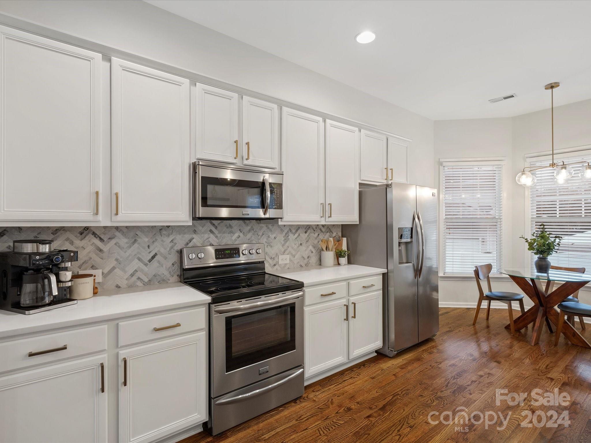 432 Third Baxter Street Fort Mill, SC 29708 - Photo 25 of 48 a kitchen with appliances a sink cabinets and a counter top space