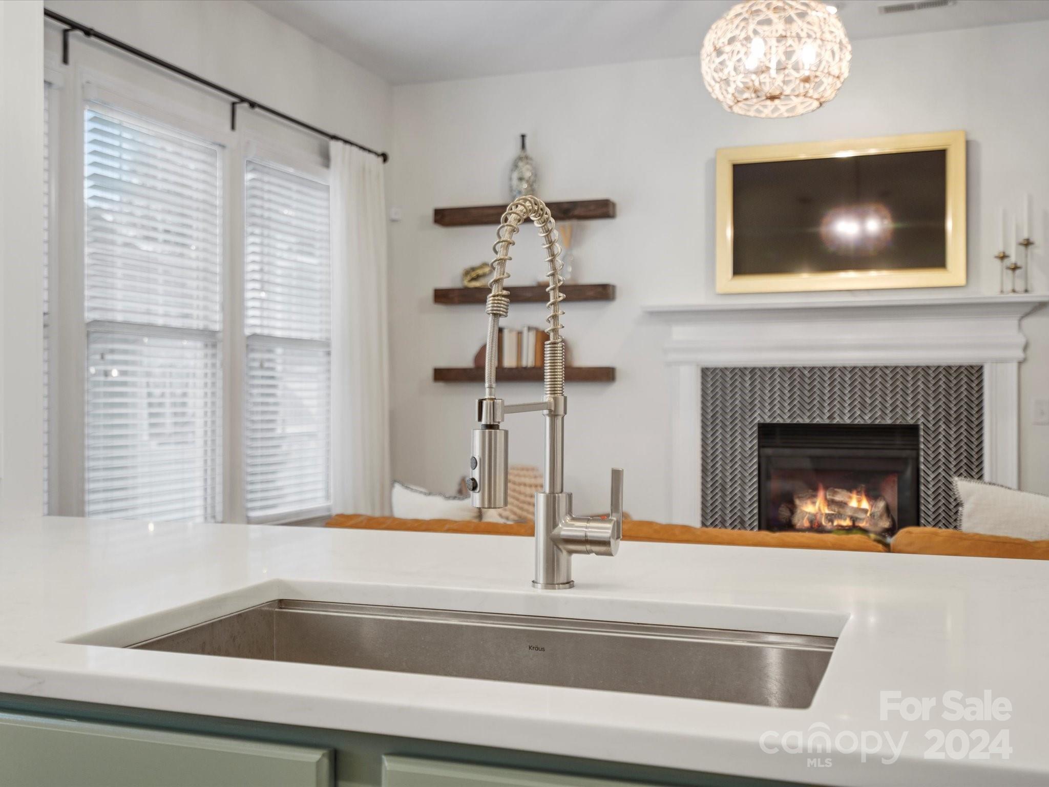 432 Third Baxter Street Fort Mill, SC 29708 - Photo 27 of 48 a view of a livingroom with a fireplace a chandelier and windows