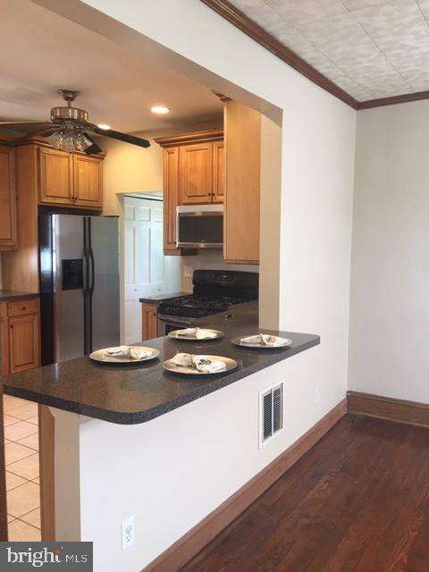 218 Chestnut Street Audubon, NJ 08106 - Photo 3 of 11 a kitchen with stainless steel appliances granite countertop a stove and a refrigerator