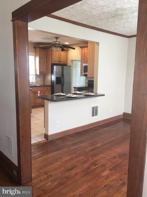 218 Chestnut Street Audubon, NJ 08106 - Photo 4 of 11 a view of a room with wooden floor and cabinet