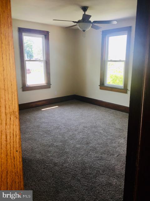 218 Chestnut Street Audubon, NJ 08106 - Photo 6 of 11 an empty room with windows and fan