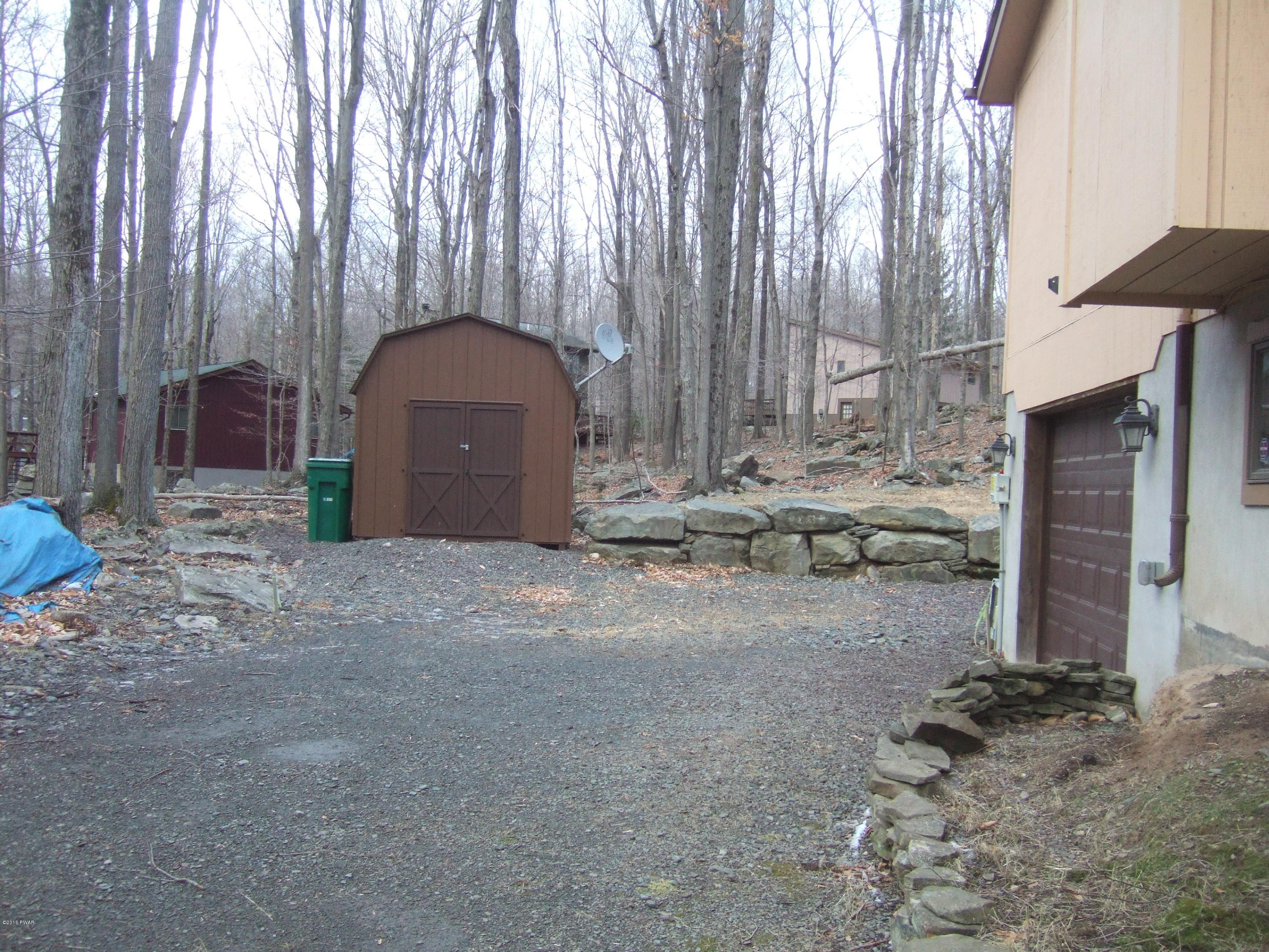 2654 Boulder Road Lake Ariel, PA 18436 - Photo 3 of 40 a backyard of a house with a large tree and wooden fence