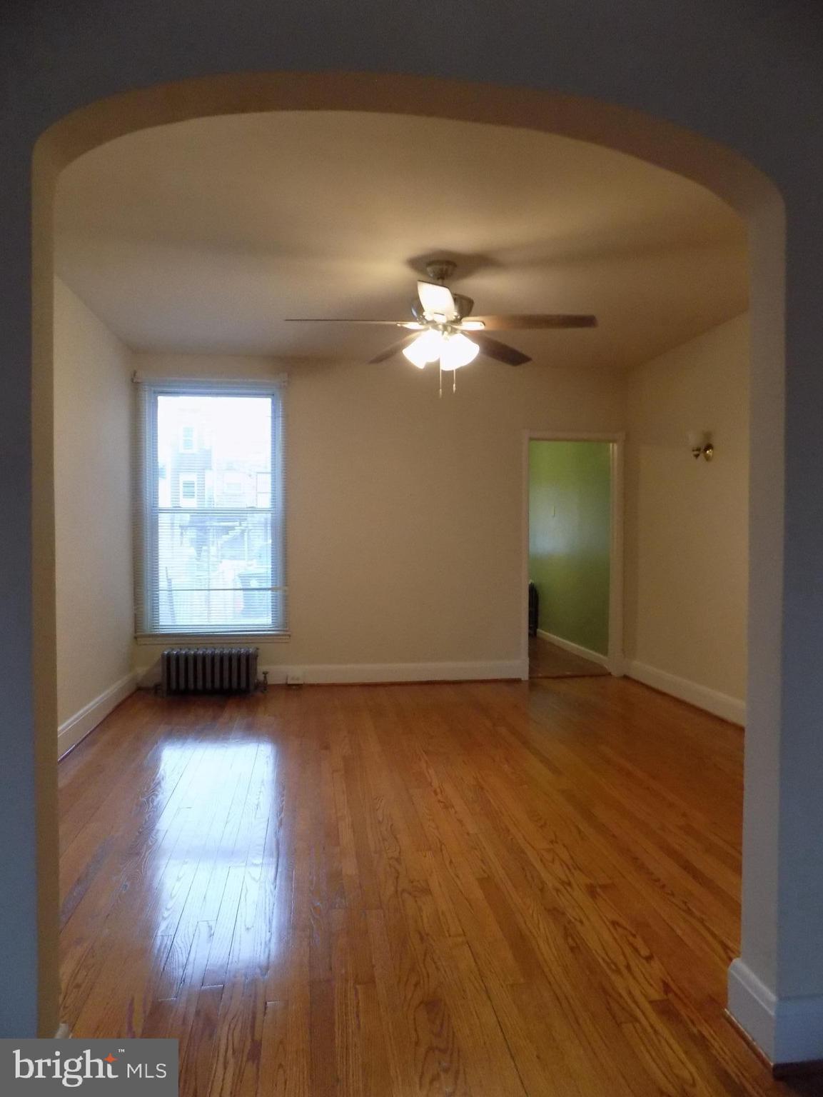 3925 Colborne Road Baltimore, MD 21229 - Photo 5 of 13 a view of a room with wooden floor and window