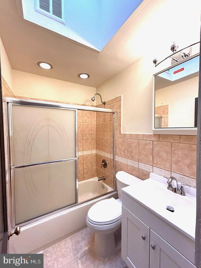 3925 Colborne Road Baltimore, MD 21229 - Photo 10 of 13 a bathroom with a sink a toilet and shower