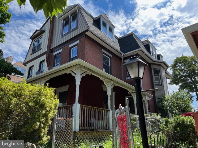 310 Earlham Terrace Philadelphia, PA 19144 - Photo 1 of 9 a view of a house with wooden fence and plants
