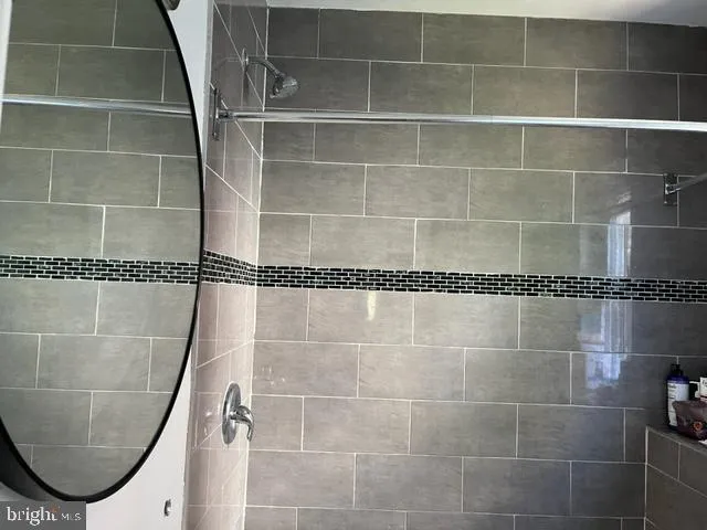 a bathroom with a shower and a mirror