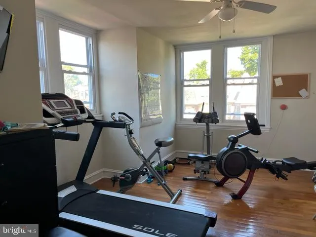 a room with gym equipment and windows