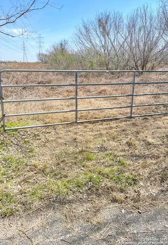 a view of empty space with wooden fence
