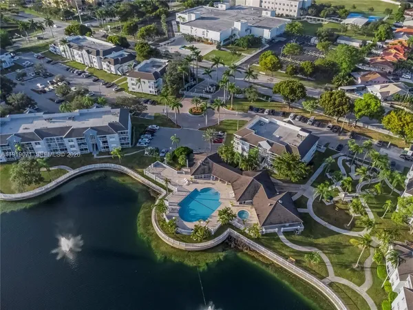 an aerial view of a house with swimming pool and outdoor seating