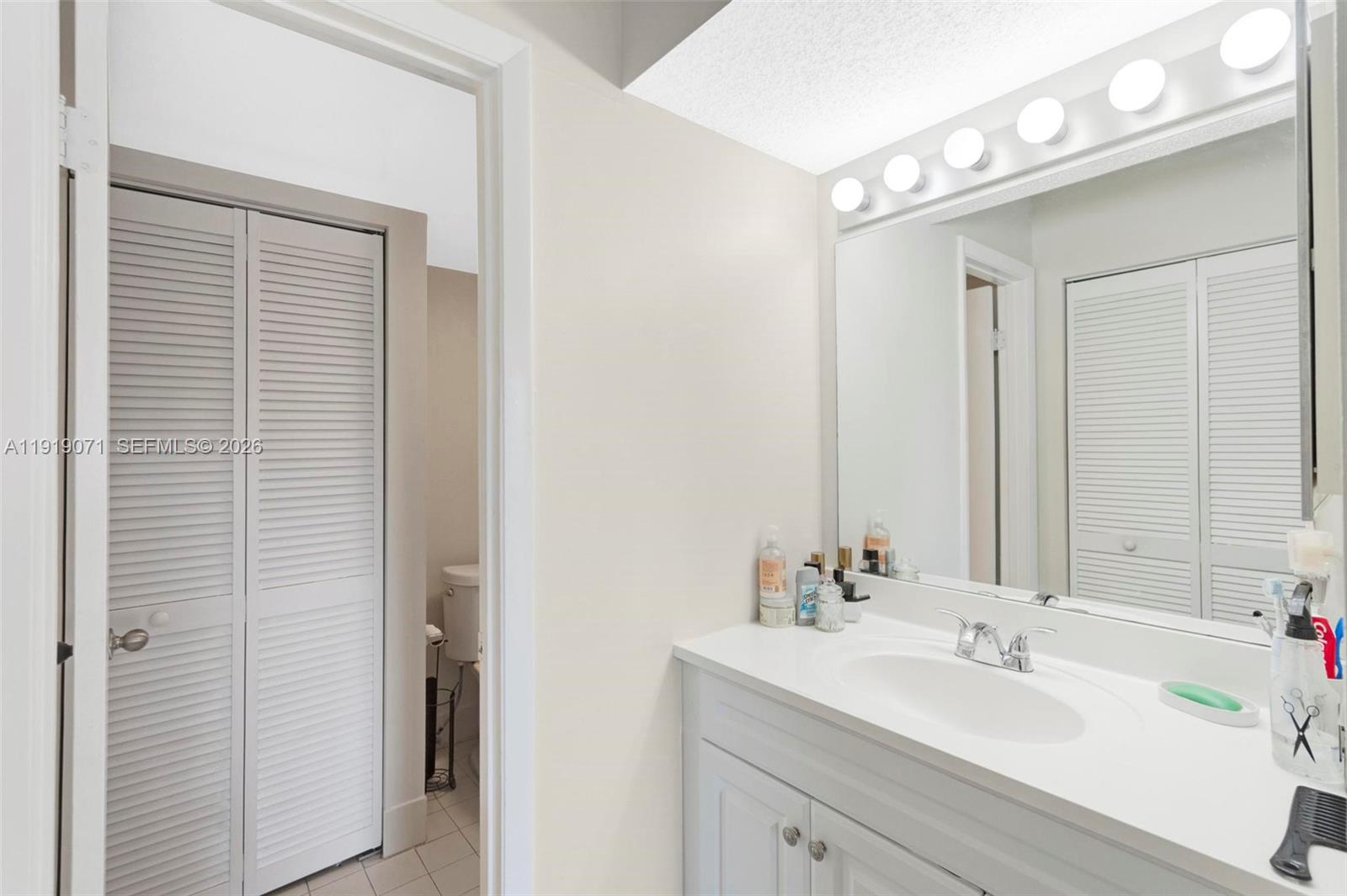 8560 Southwest 212th Street, Unit 308 Cutler Bay, FL 33189 - Photo 11 of 21 a bathroom with a sink and a mirror