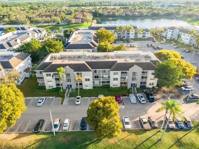 an aerial view of a house with outdoor seating