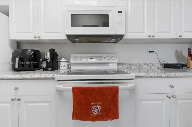 a kitchen with a stove and cabinets