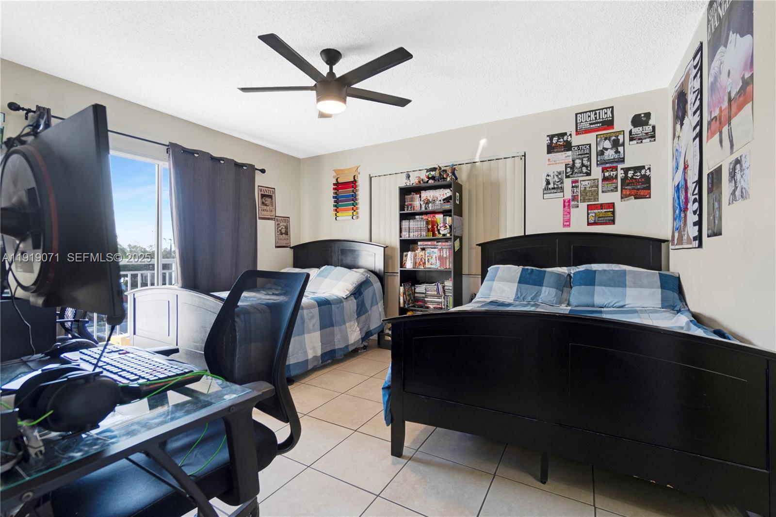 8560 Southwest 212th Street, Unit 308 Cutler Bay, FL 33189 - Photo 10 of 26 a bedroom with a bed and a desk