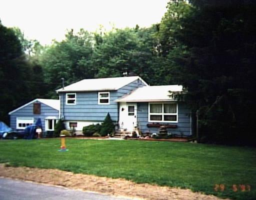 27 Northwood Road Monroe, CT 06468 - Photo 1 of 1 a front view of a house with a garden and porch