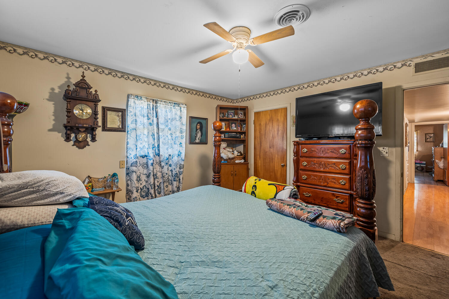 2513 52nd Street Lubbock, TX 79413 - Photo 17 of 29 a bedroom with a bed and a flat screen tv