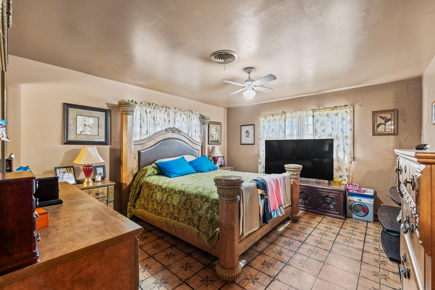 2513 52nd Street Lubbock, TX 79413 - Photo 19 of 29 a bed room with a bed and a flat screen tv