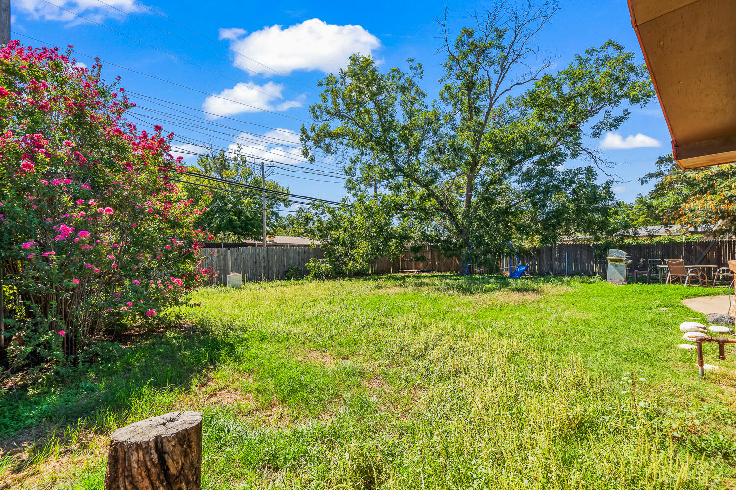 2513 52nd Street Lubbock, TX 79413 - Photo 26 of 29 a view of a backyard with potted plants and large tree