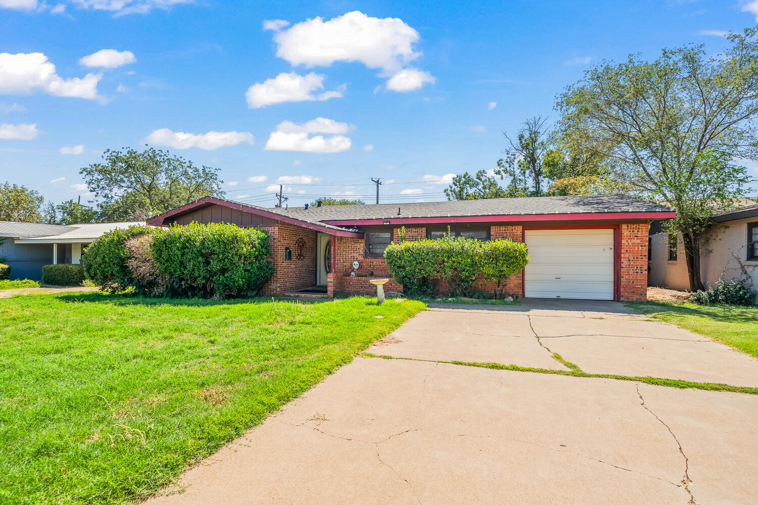 2513 52nd Street Lubbock, TX 79413 - Photo 3 of 29 a front view of a house with a yard and garage