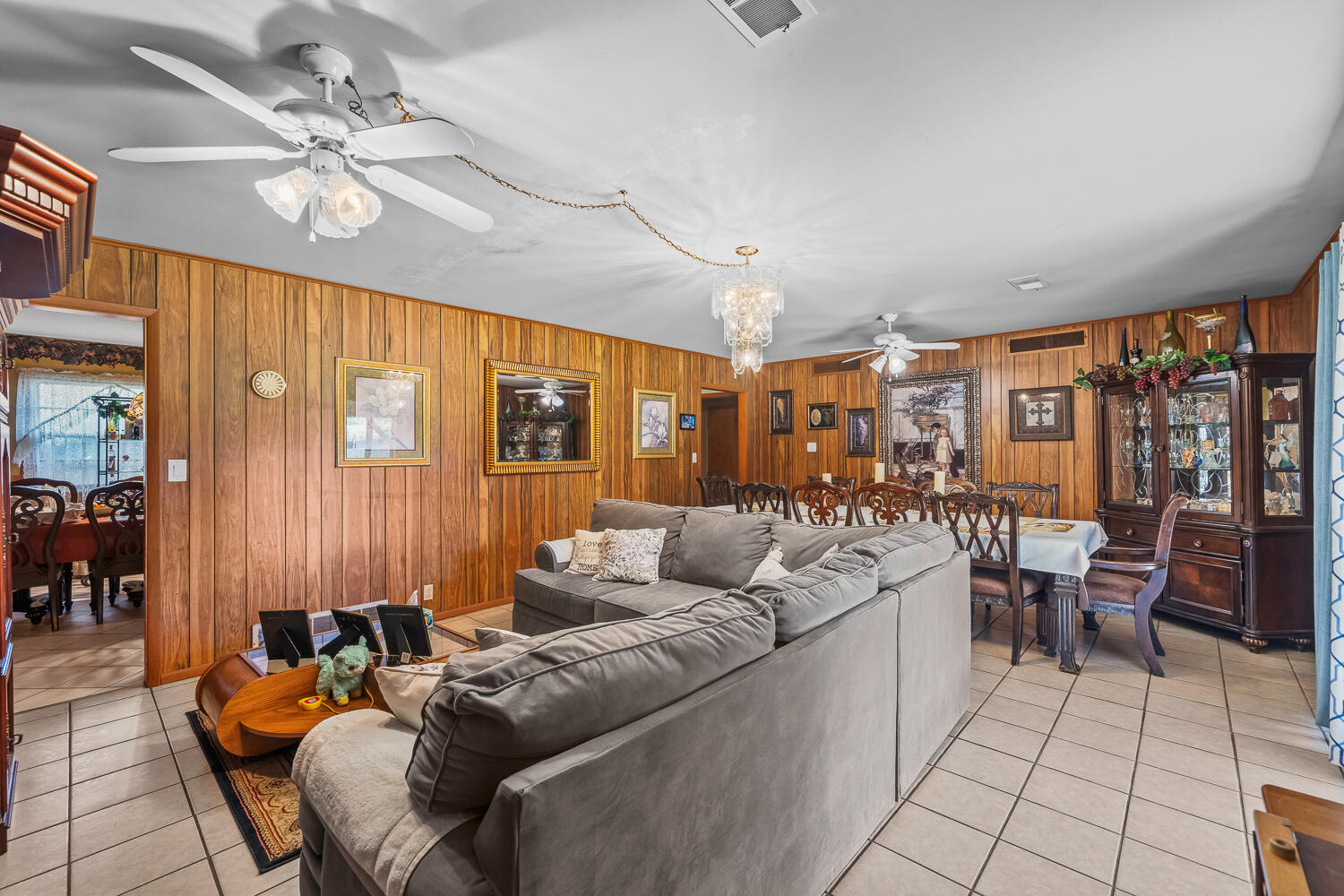 2513 52nd Street Lubbock, TX 79413 - Photo 7 of 29 a living room with furniture a chandelier and a large window