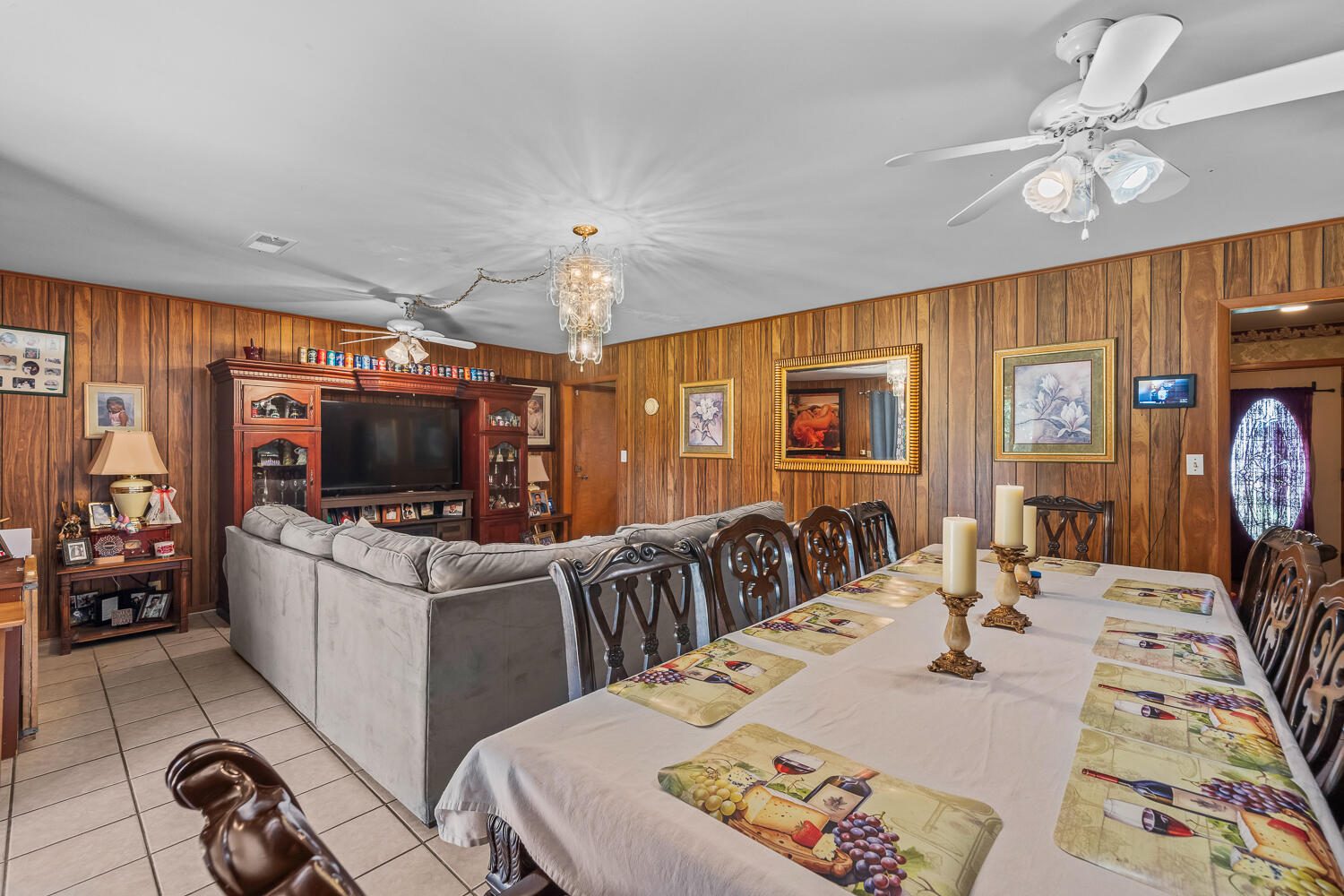 2513 52nd Street Lubbock, TX 79413 - Photo 8 of 29 a living room with furniture a flat screen tv and a chandelier