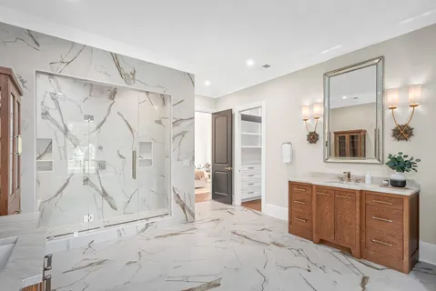 a spacious bathroom with a shower sink and mirror