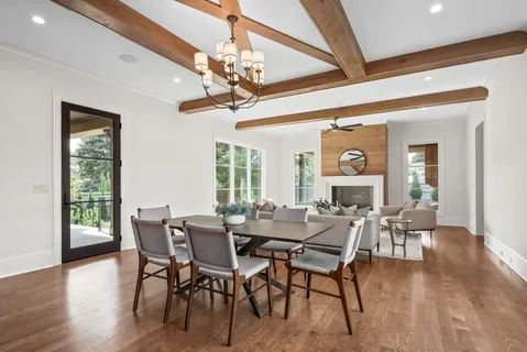 a view of a dining room with furniture wooden floor and chandelier
