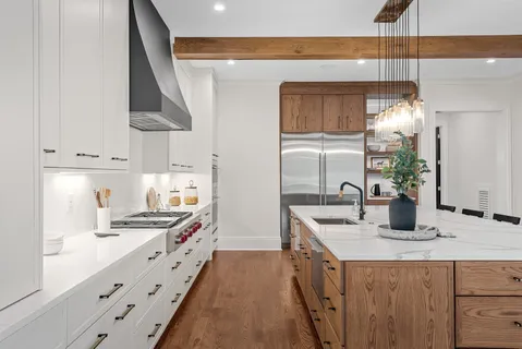 a kitchen with stainless steel appliances a sink stove and cabinets
