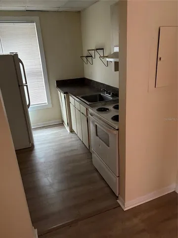 a kitchen with granite countertop a stove and a refrigerator