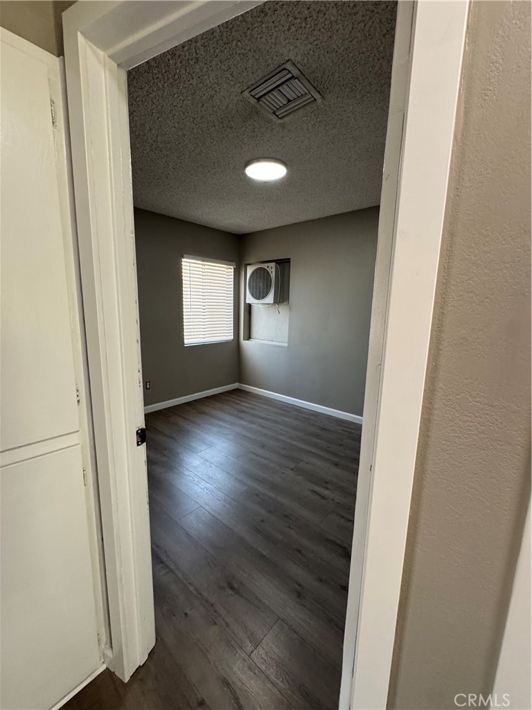 43343 17th Street West Lancaster, CA 93534 - Photo 5 of 20 an empty room with wooden floor and windows