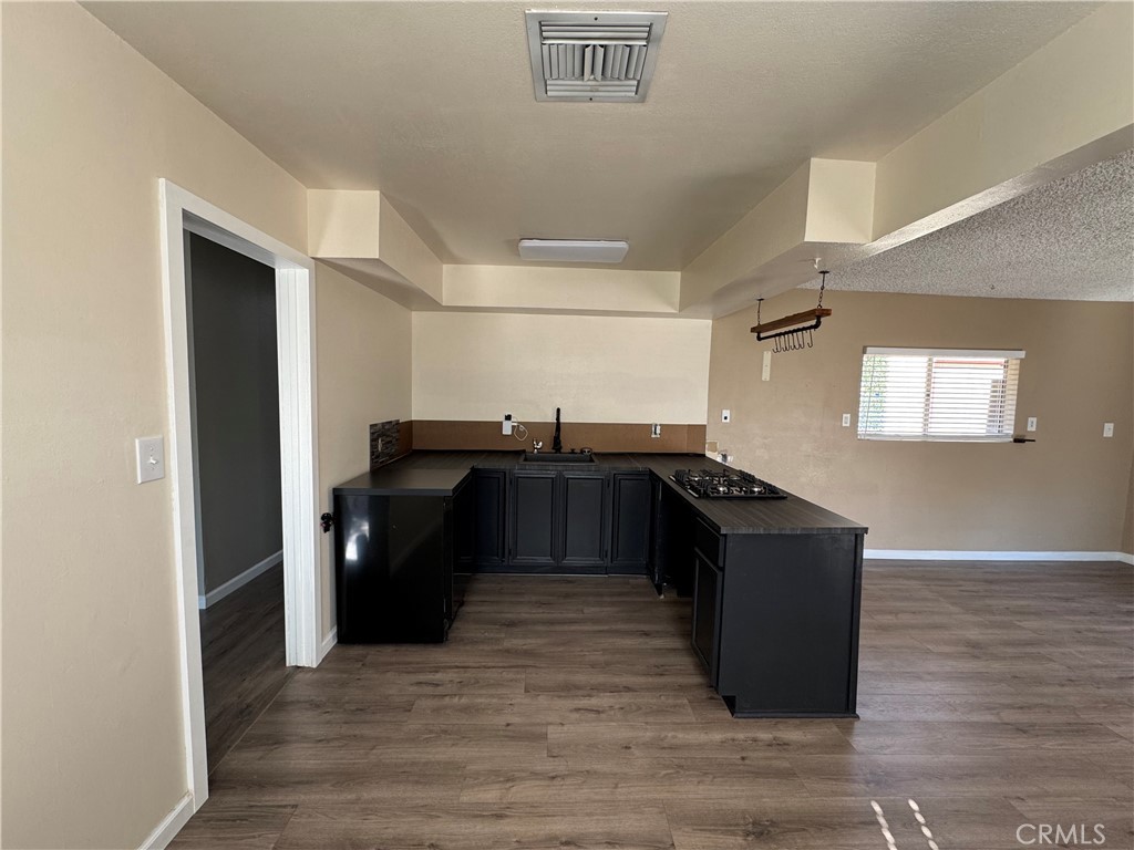 43343 17th Street West Lancaster, CA 93534 - Photo 7 of 20 a kitchen with granite countertop a refrigerator and a sink