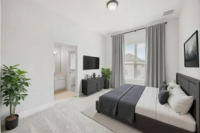 a bedroom with a bed and a flat screen television