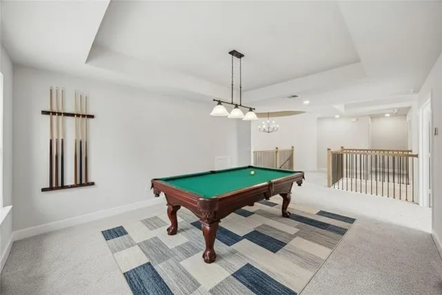 a room with pool table and a chandelier