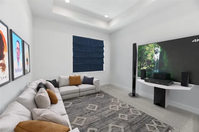 a living room with furniture ceiling fan and a rug