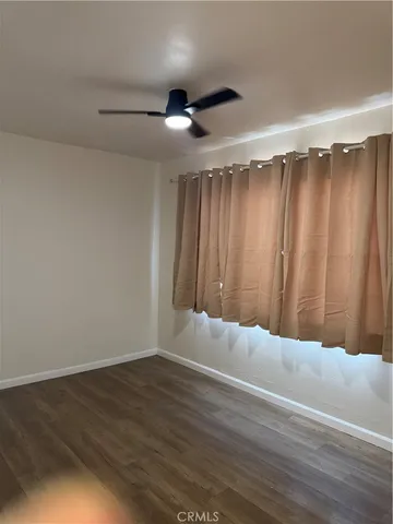 a bathroom with a granite countertop toilet sink and mirror