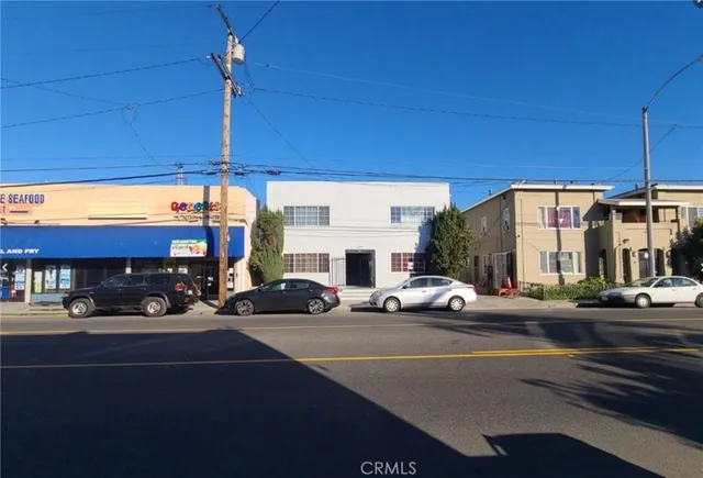 a view of a building with car parked