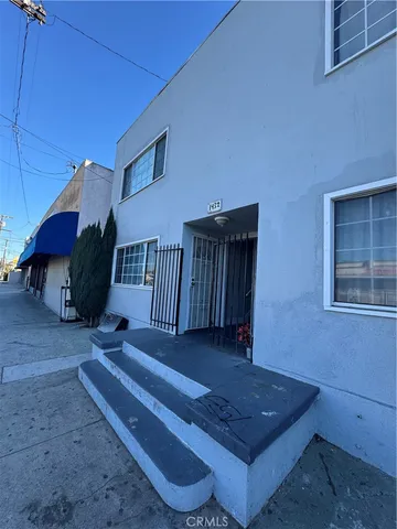 a living room with couch and a table with potted plants