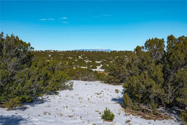 a view of a beach with a mountain in the background