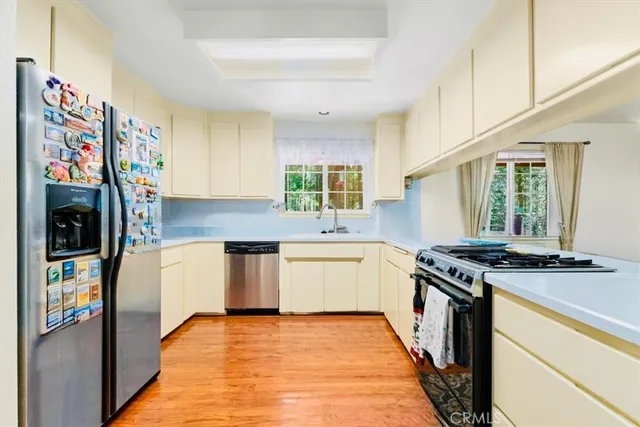 a kitchen with stainless steel appliances granite countertop a stove a sink and a refrigerator